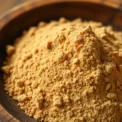 High-quality nutmeg powder in a wooden bowl showcasing its rich aroma and fine texture for