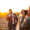 Professional eskuvo fotos capturing a joyful bride and groom during sunset outdoor wedding,